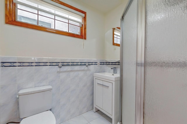 full bath featuring vanity, tile patterned floors, a healthy amount of sunlight, and a stall shower