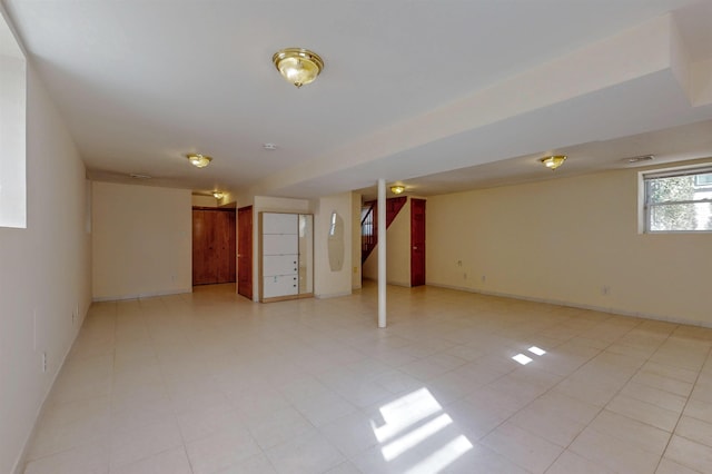 below grade area featuring stairway, visible vents, and baseboards