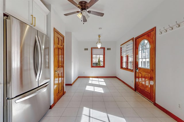 entryway with light tile patterned floors, visible vents, baseboards, and a ceiling fan