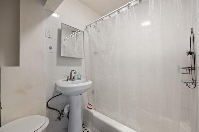 full bathroom with toilet, shower / tub combo, and tile walls