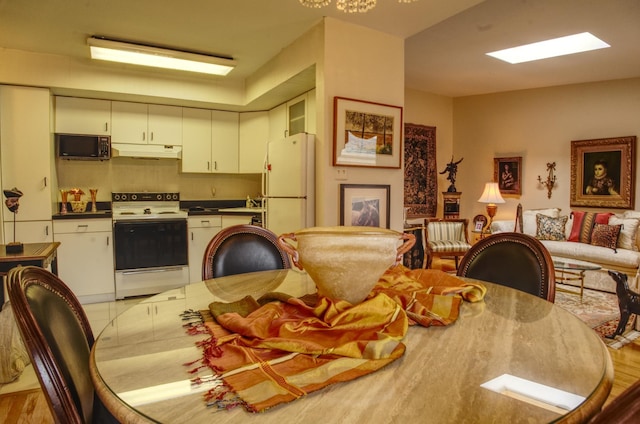 dining space featuring sink and light hardwood / wood-style flooring