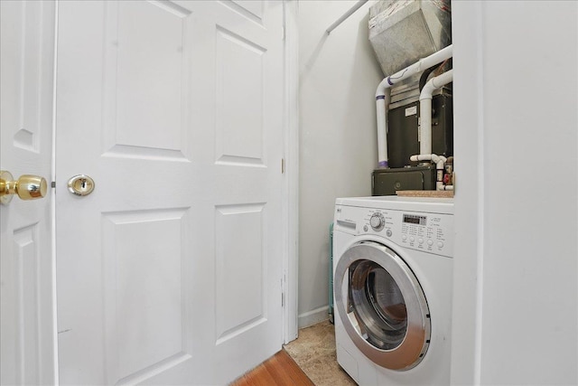 laundry area with washer / clothes dryer and heating unit