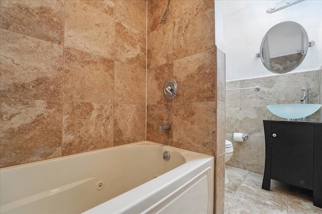full bathroom featuring toilet, tile walls, vanity, and shower / bathtub combination