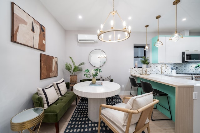 interior space featuring backsplash, a wall mounted air conditioner, hanging light fixtures, a notable chandelier, and a sink