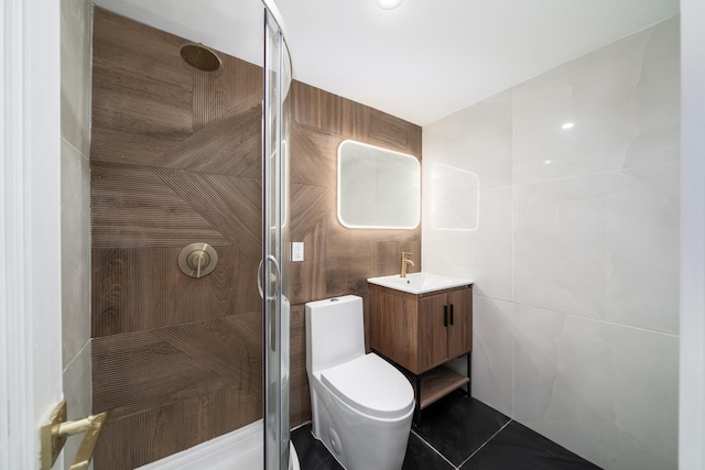 full bathroom featuring vanity, a shower stall, and tile walls