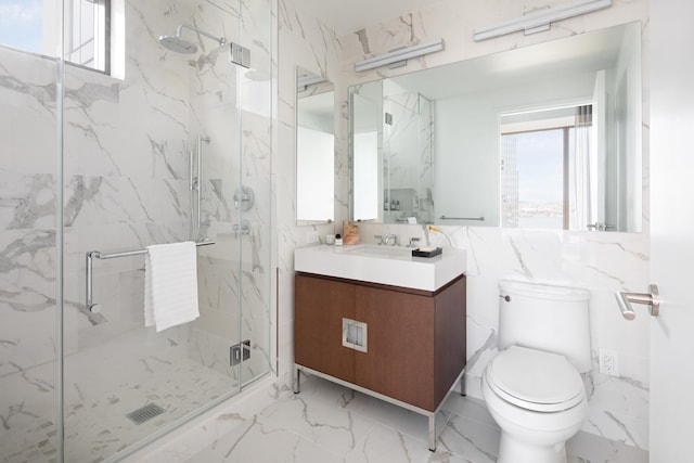 bathroom featuring vanity, toilet, an enclosed shower, and a healthy amount of sunlight