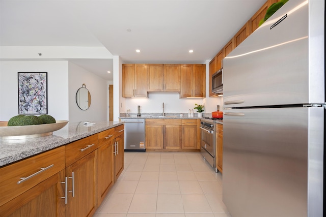 20 Newport Pkwy Unit 1707, Jersey City, NJ 07310 - kitchen with appliances with stainless steel finishes, light tile patterned flooring, light stone counters, recessed lighting, and brown cabinets