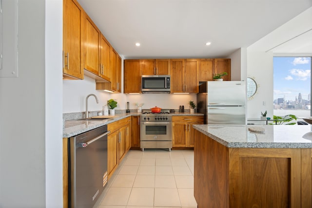 20 Newport Pkwy Unit 1707, Jersey City, NJ 07310 - kitchen featuring stainless steel appliances, light tile patterned floors, brown cabinets, light stone counters, and recessed lighting