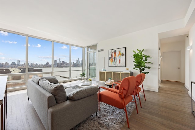 20 Newport Pkwy Unit 1707, Jersey City, NJ 07310 - living area with a view of skyline, wood-type flooring, and a wall of windows