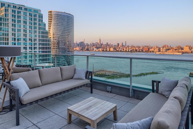 20 Newport Pkwy Unit 1707, Jersey City, NJ 07310 - balcony at dusk with a skyline view, outdoor lounge area, and a water view