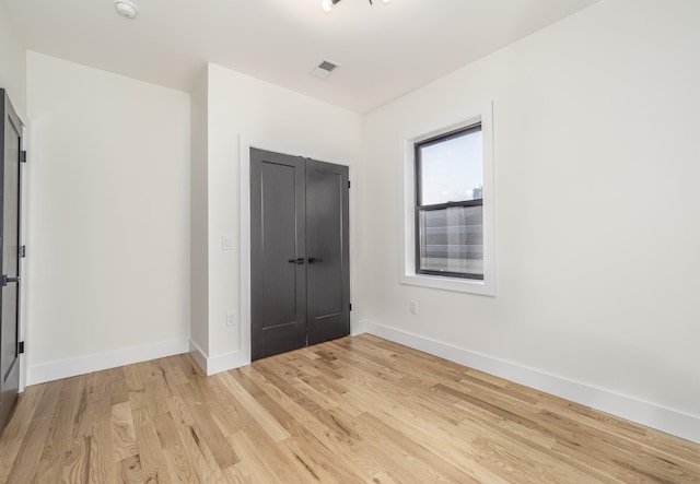 empty room with light hardwood / wood-style floors