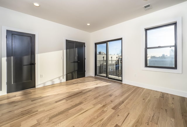 empty room with light hardwood / wood-style floors