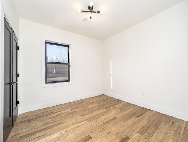 unfurnished room with light wood-type flooring