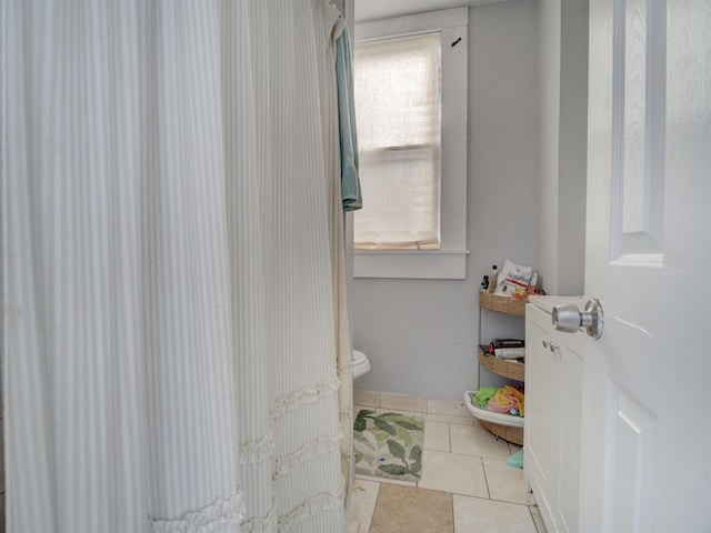 bathroom with tile patterned flooring and toilet