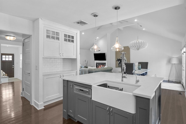 65 Dillingham Pl, Englewood Cliffs, NJ 07632 - kitchen featuring gray cabinets, light countertops, a kitchen island with sink, visible vents, and a sink