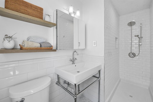65 Dillingham Pl, Englewood Cliffs, NJ 07632 - bathroom with tile walls, toilet, tiled shower, and a wainscoted wall