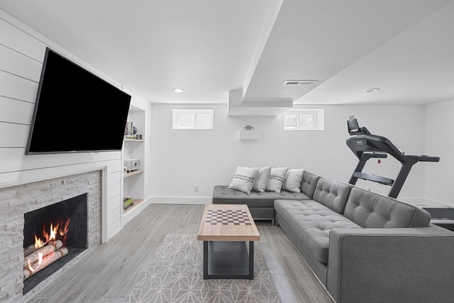 65 Dillingham Pl, Englewood Cliffs, NJ 07632 - living area featuring light wood-style floors, built in features, a fireplace, visible vents, and baseboards