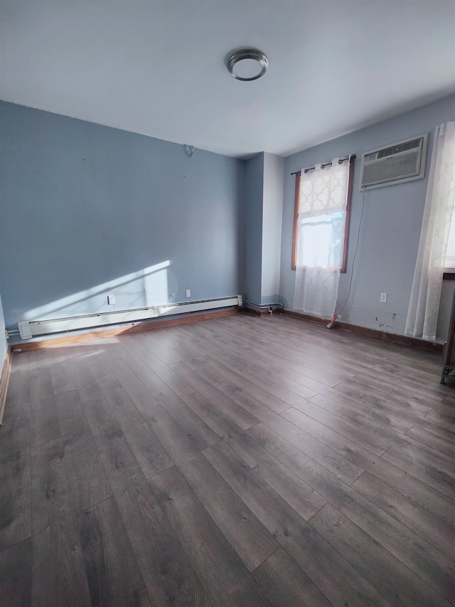 empty room featuring a baseboard radiator, dark wood-type flooring, and a wall unit AC