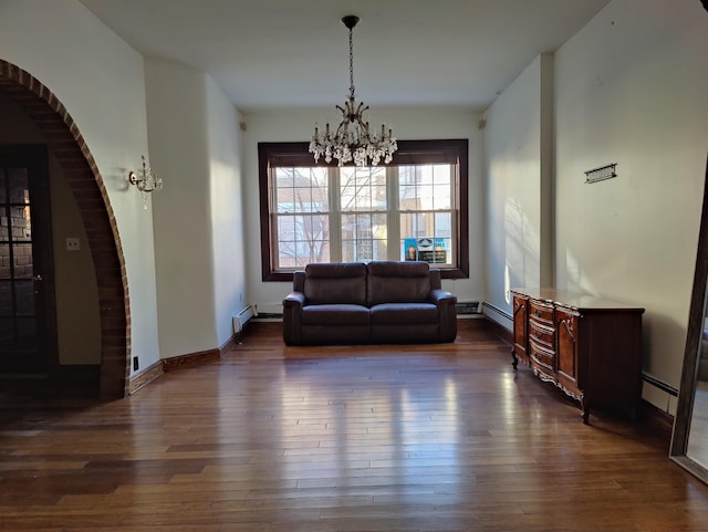 interior space with a baseboard radiator, dark wood-type flooring, and a notable chandelier