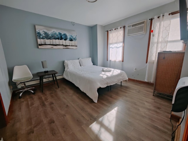 bedroom with a wall mounted air conditioner, dark wood-type flooring, and a baseboard radiator