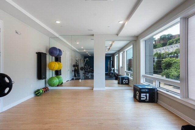 exercise area with light wood-type flooring, plenty of natural light, baseboards, and recessed lighting