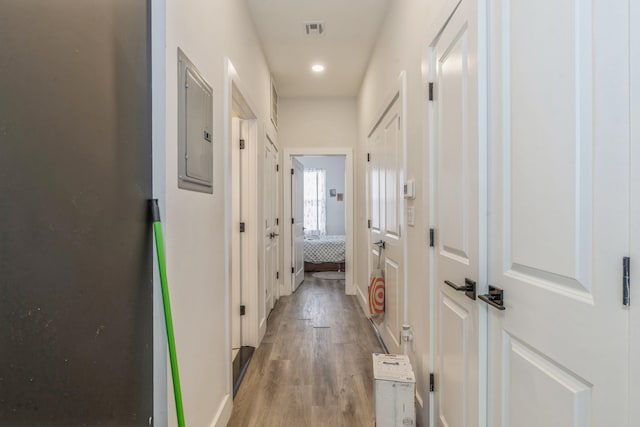 hall featuring electric panel and light wood-type flooring