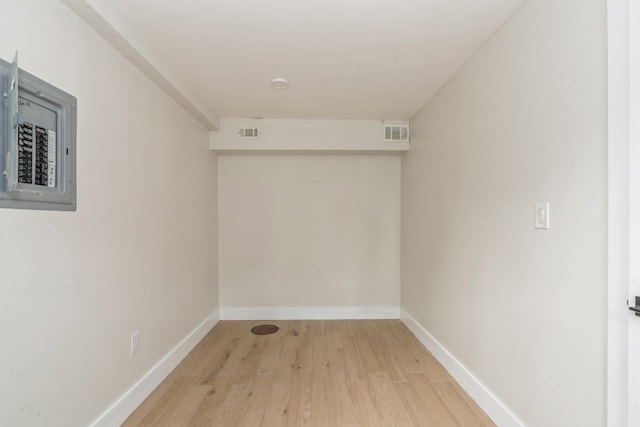 interior space with light wood-type flooring and electric panel