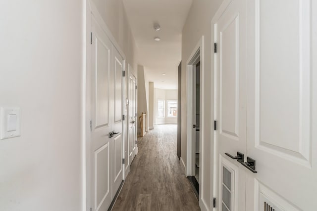 hallway with dark hardwood / wood-style floors