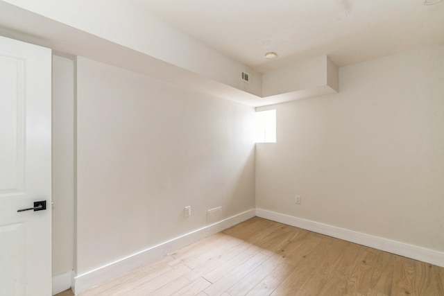 spare room with light hardwood / wood-style flooring