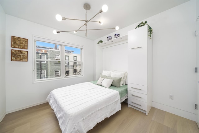 415 Monmouth St Apt. Three, Apt Three, Jersey City, NJ 07302 - bedroom with a chandelier and wood finished floors