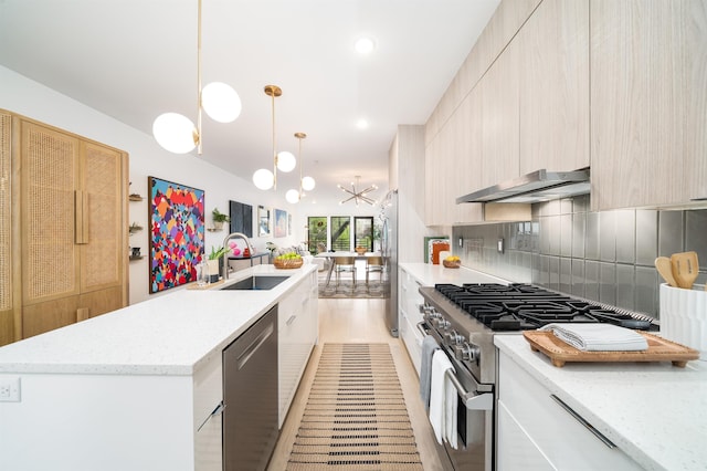415 Monmouth St Apt. Three, Apt Three, Jersey City, NJ 07302 - kitchen with appliances with stainless steel finishes, range hood, modern cabinets, a center island with sink, and backsplash