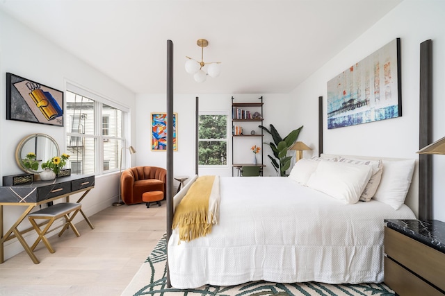 415 Monmouth St Apt. Three, Apt Three, Jersey City, NJ 07302 - bedroom with light wood finished floors and a chandelier