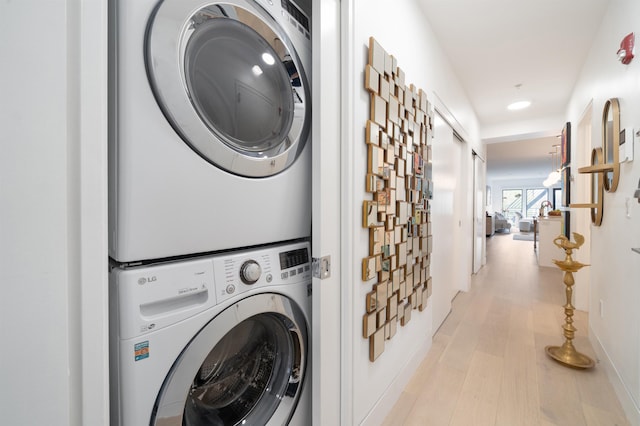 415 Monmouth St Apt. Three, Apt Three, Jersey City, NJ 07302 - washroom featuring estacked washer and dryer, light wood-type flooring, and recessed lighting