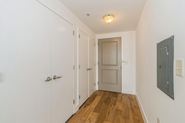 88 Morgan St Unit 2601, Jersey City, NJ 07302 - hallway featuring electric panel, light wood-style flooring, and baseboards