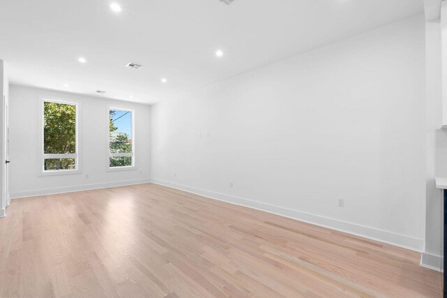 unfurnished living room featuring light wood-style flooring, visible vents, baseboards, and recessed lighting