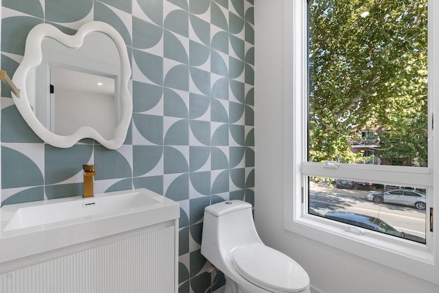 bathroom featuring vanity and toilet