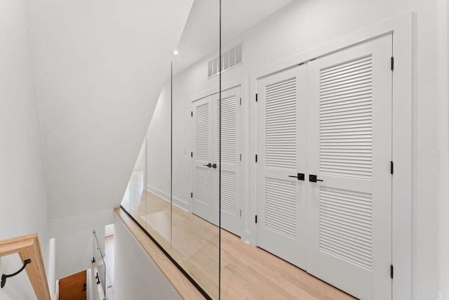 hall with light wood-type flooring and visible vents