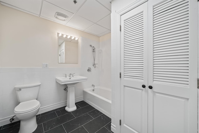 300 Communipaw Ave Unit 122, Jersey City, NJ 07304 - full bath featuring shower / washtub combination, tile walls, a closet, tile patterned flooring, and wainscoting