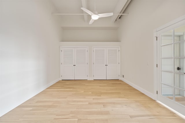 300 Communipaw Ave Unit 122, Jersey City, NJ 07304 - unfurnished bedroom with two closets, light wood-style floors, high vaulted ceiling, and a ceiling fan