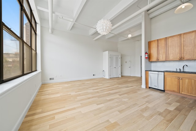 300 Communipaw Ave Unit 122, Jersey City, NJ 07304 - kitchen with dishwasher, tasteful backsplash, light wood-style floors, dark countertops, and beam ceiling