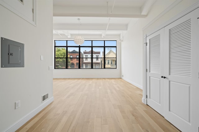 300 Communipaw Ave Unit 122, Jersey City, NJ 07304 - hallway featuring electric panel, beam ceiling, light wood-style floors, and a chandelier