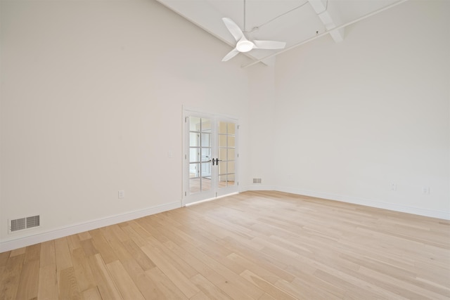 300 Communipaw Ave Unit 122, Jersey City, NJ 07304 - spare room featuring french doors, light wood-style flooring, high vaulted ceiling, and ceiling fan