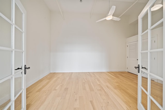 300 Communipaw Ave Unit 122, Jersey City, NJ 07304 - empty room featuring french doors, wood finished floors, a ceiling fan, and lofted ceiling