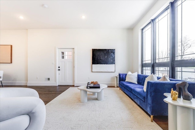 living room with recessed lighting, wood finished floors, visible vents, and baseboards