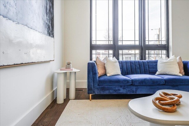 living area featuring dark wood finished floors and baseboards