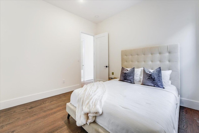bedroom featuring wood finished floors and baseboards