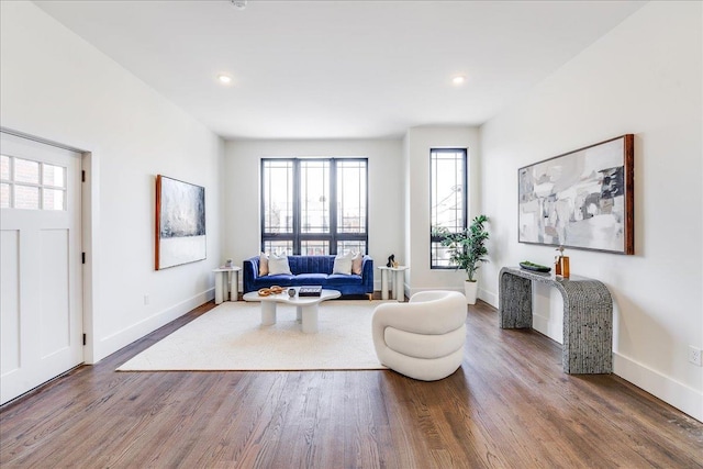 living room with recessed lighting, baseboards, and wood finished floors