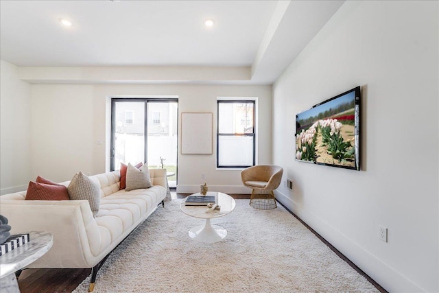 living room featuring recessed lighting, visible vents, baseboards, and wood finished floors