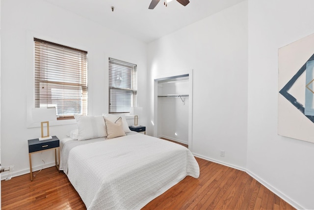 bedroom with a closet, baseboards, ceiling fan, and wood finished floors