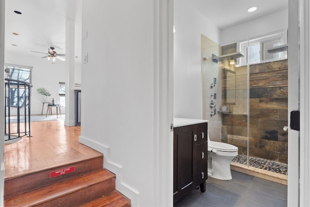 full bathroom with ceiling fan, plenty of natural light, a stall shower, and vanity